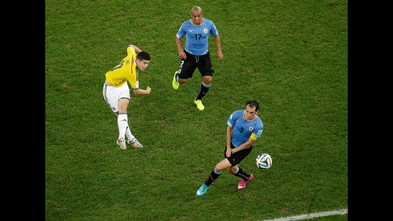 Rodriguez shoots and scores his team's first goal against Uruguay.