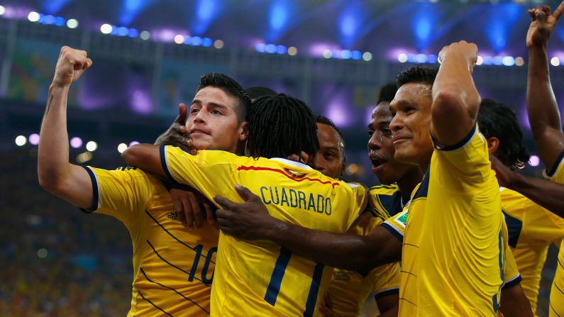 James Rodriguez of Colombia, left, celebrates scoring his team's second goal against Uruguay in Rio de Janeiro on Saturday, June 28. Colombia won the game 2-0 to advance to the quarterfinals. Rodriguez had both goals.