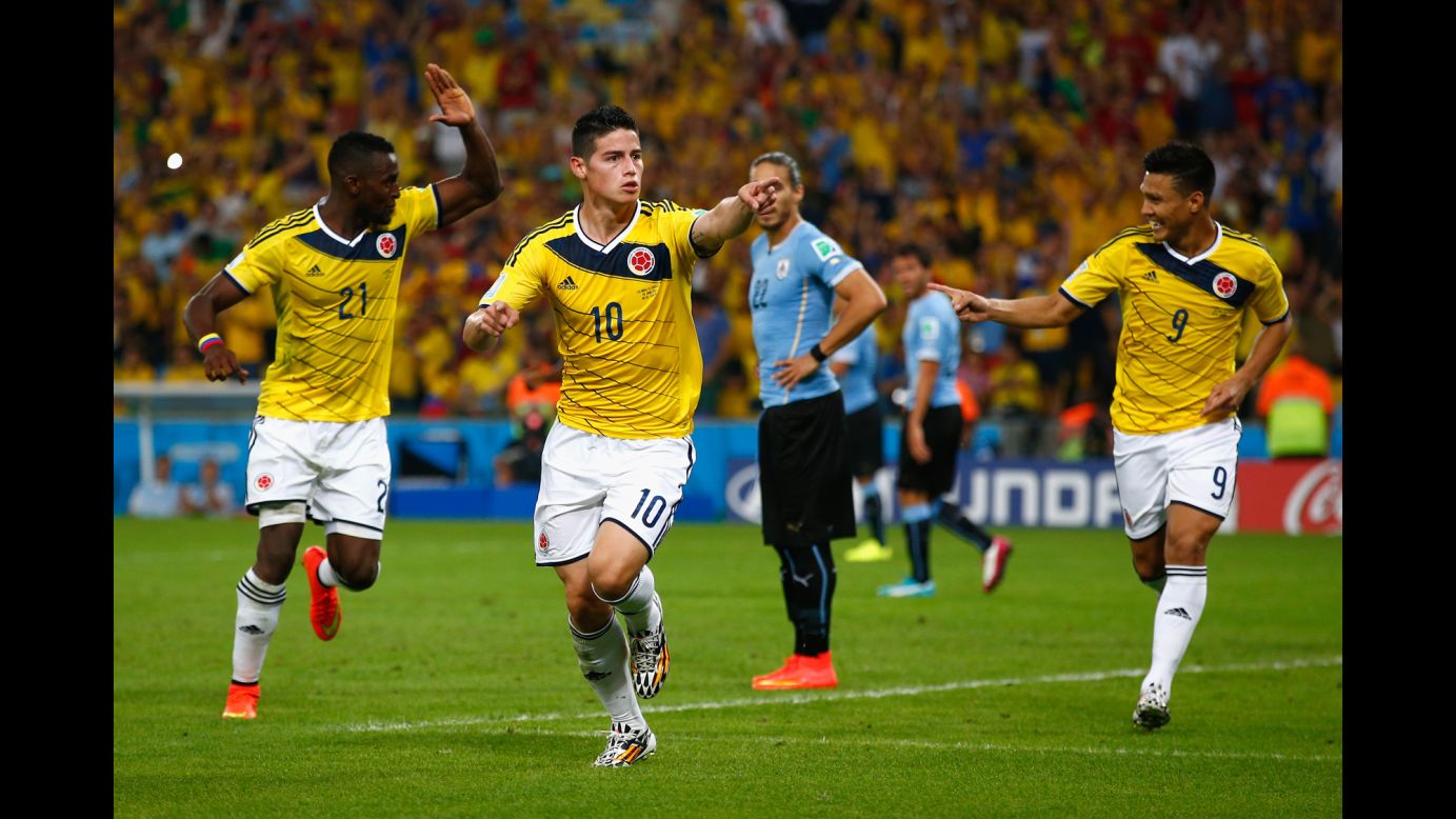 James Rodriguez of Colombia, center, celebrates scoring his team's second goal and his second during the World Cup game between Colombia and Uruguay in Rio de Janeiro on Saturday, June 28. Rodriguez set the record of most goals by one player in this World Cup with five goals to his name.