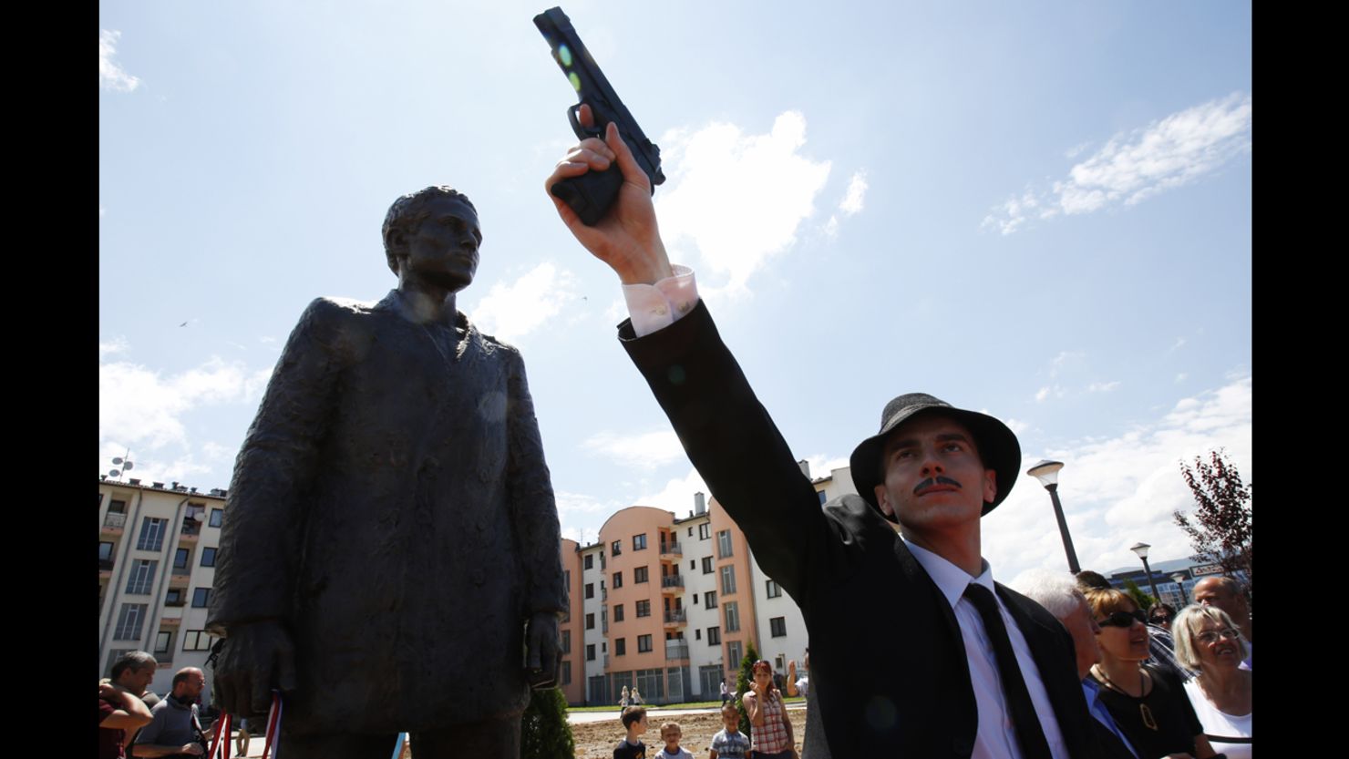 Bosnian actor Jovan Mojsilovic poses with a plastic gun replica at the unveiling of a statue of Gavrilo Princip in Sarajevo, June 27.