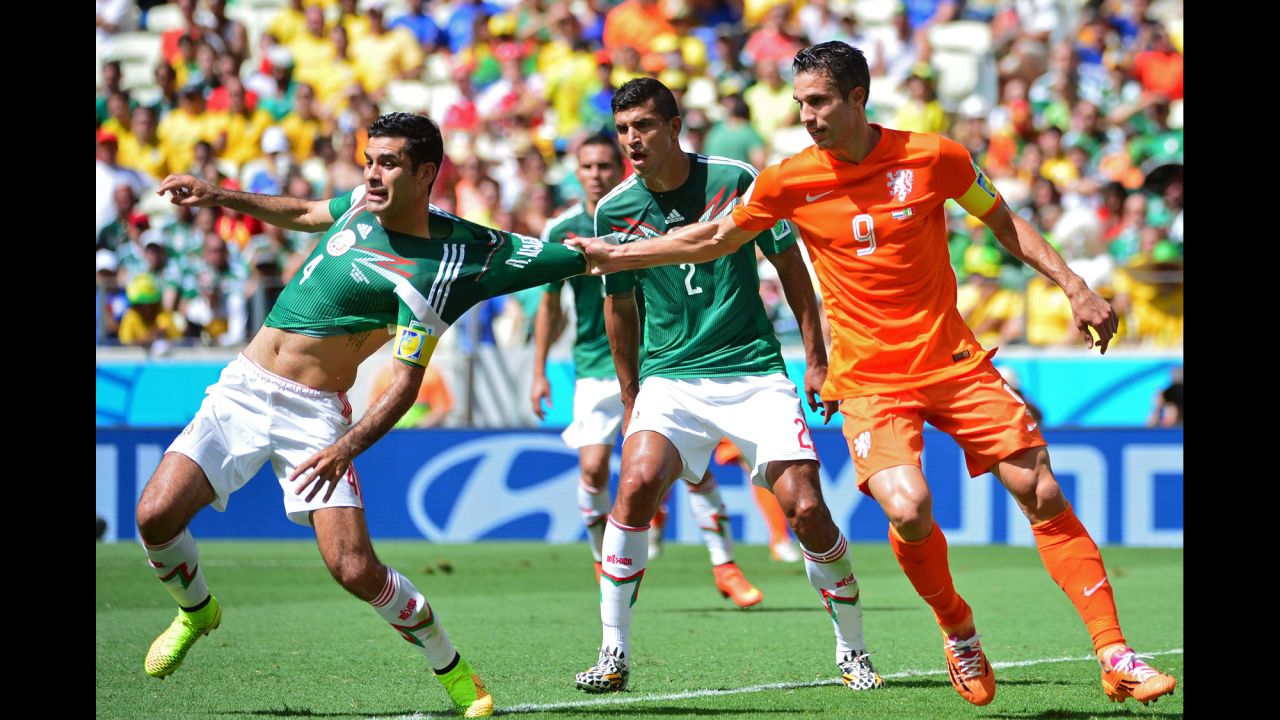 Netherlands forward Robin van Persie pulls the jersey of Mexico's captain Rafael Marquez.