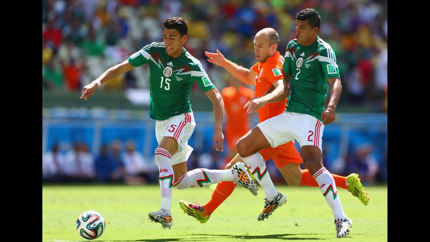 Arjen Robben of the Netherlands is challenged by Hector Moreno, left, and Francisco Javier Rodriguez of Mexico.
