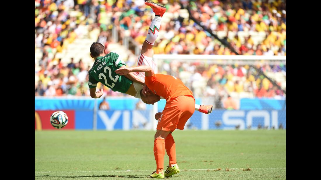 Arjen Robben of the Netherlands, right, is challenged by Paul Aguilar of Mexico.
