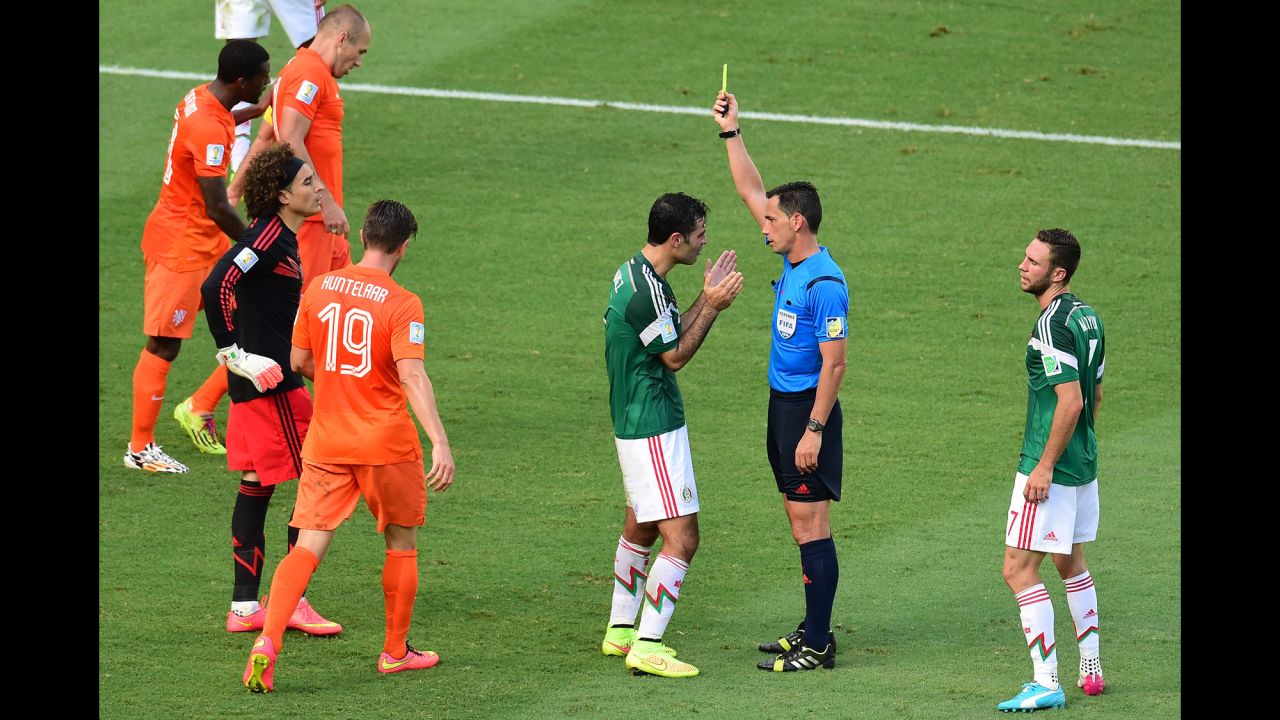 Mexico's captain, Rafael Marquez, is shown a yellow card by referee Pedro Proenca Oliveira Alves Garcia, which led to Huntelaar's penalty kick.