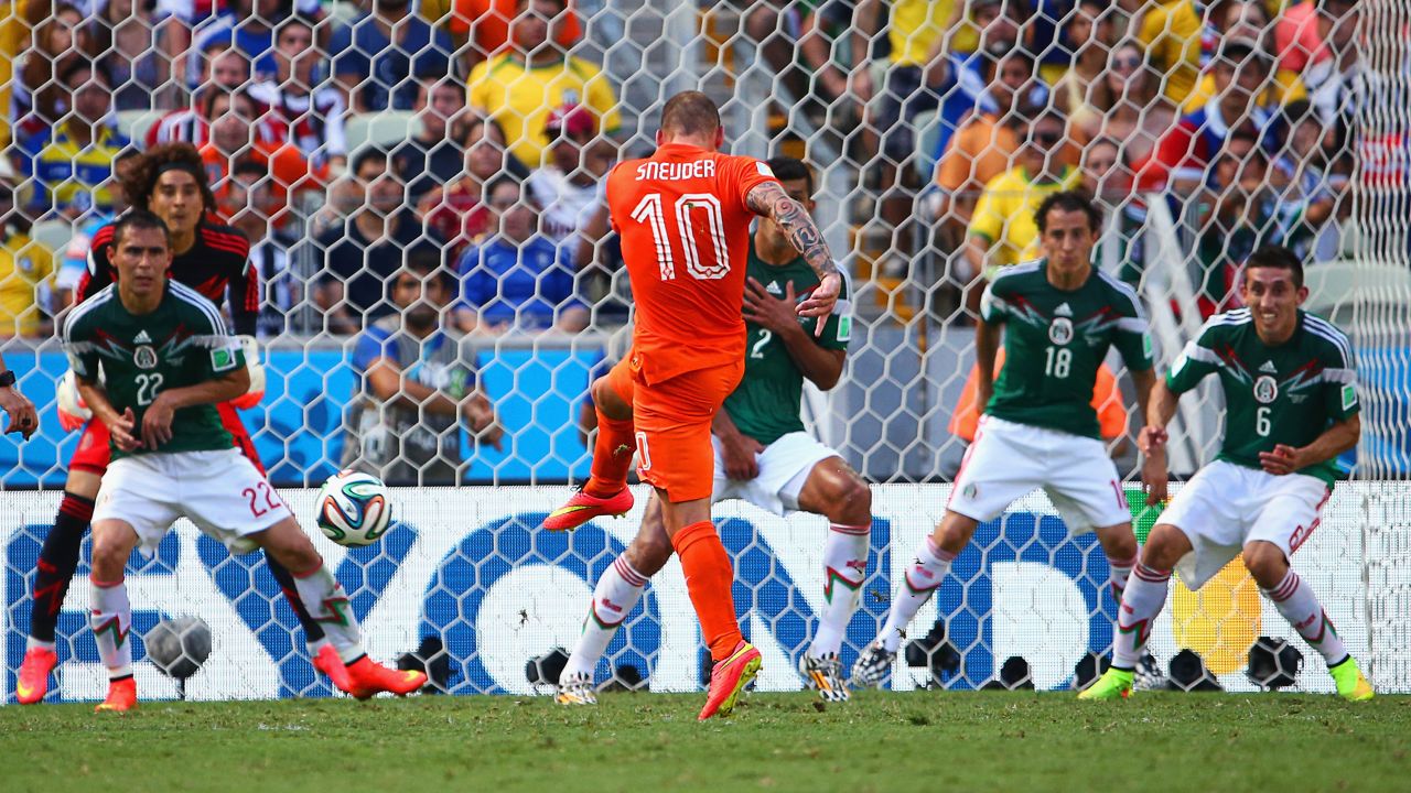 Wesley Sneijder of the Netherlands shoots and scores his team's first goal.