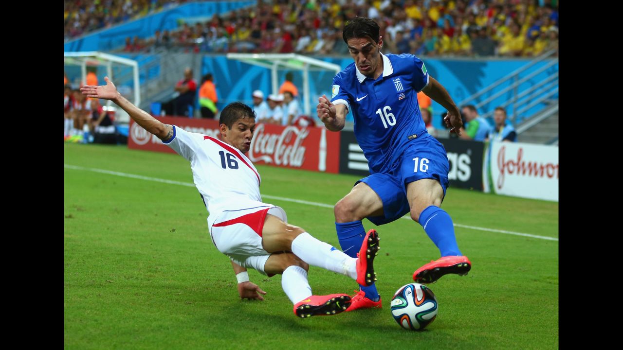 Cristian Gamboa of Costa Rica tackles Lazaros Christodoulopoulos of Greece.