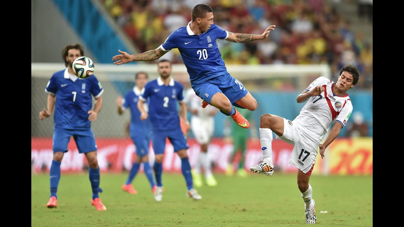 Jose Holebas of Greece, left, vies with Yeltsin Tejeda of Costa Rica for the ball.