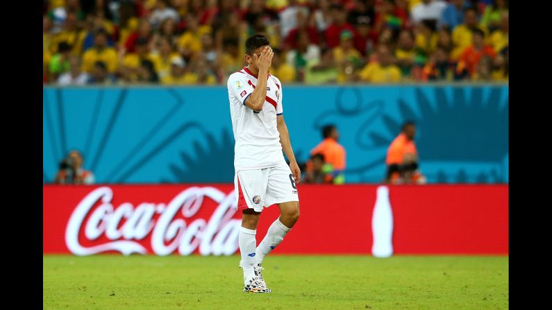 Oscar Duarte of Costa Rica walks off the pitch after being shown a red card, taking the Costa Rican team down to 10 men against Greece. 