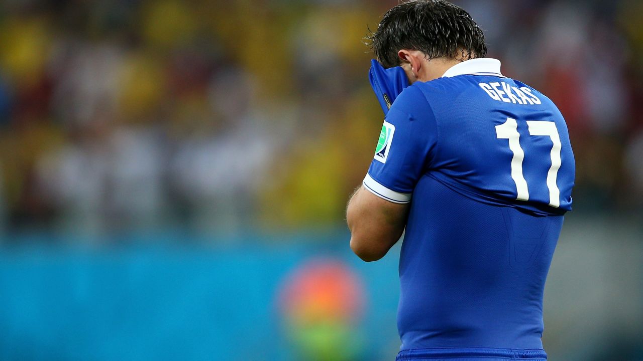 Theofanis Gekas of Greece walks away after having his shot blocked by Costa Rica's goalkeeper in a penalty shootout.