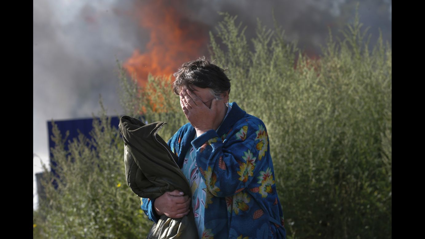 A woman cries as her house burns after a bombing in Slovyansk on Monday, June 30.