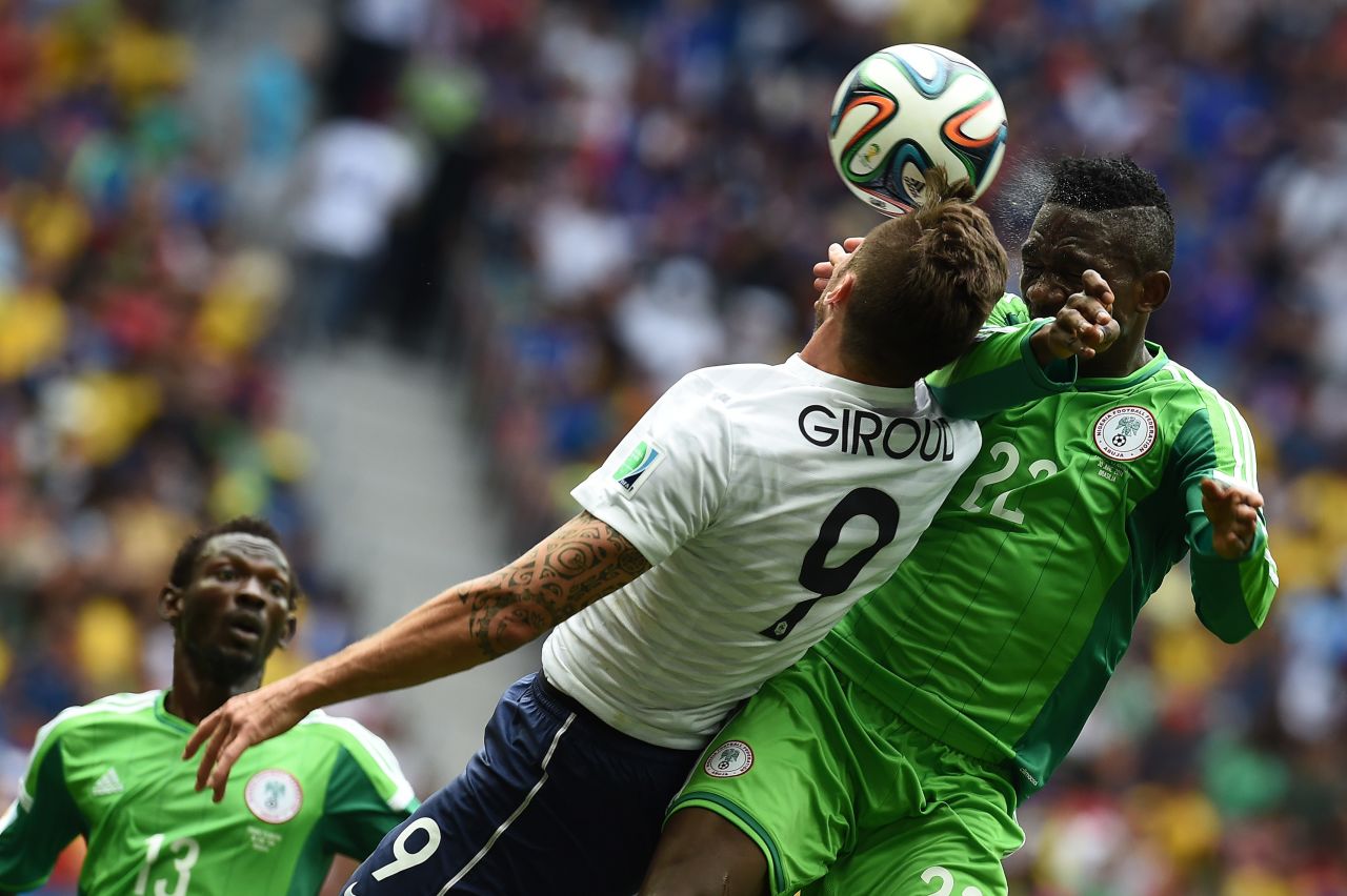 Giroud heads the ball near Omeruo.