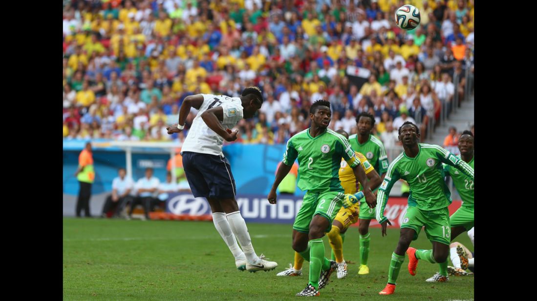 Paul Pogba of France heads in his team's first goal against Nigeria.