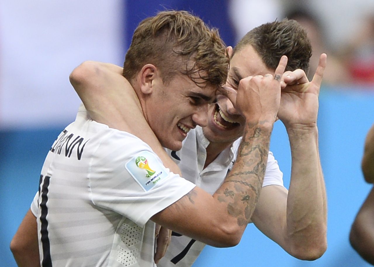 France's Antoine Griezmann, left, and Laurent Koscielny celebrate after a second goal was scored during a World Cup match against Nigeria on June 30. France won 2-0 in Brasilia, Brazil, advancing to the quarterfinals of the soccer tournament. 