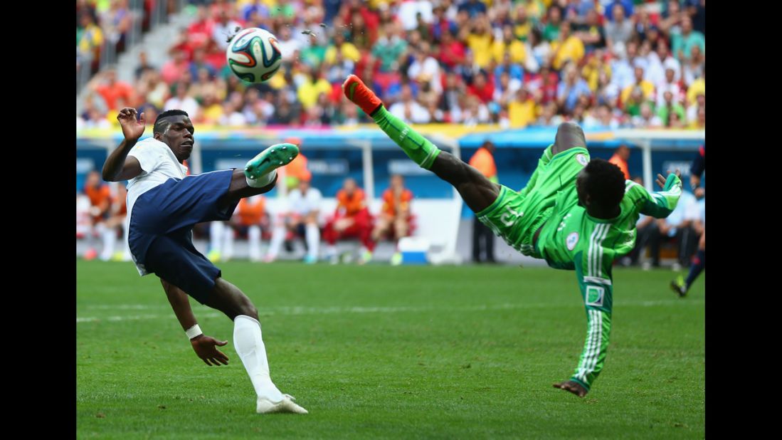 Pogba and Juwon Oshaniwa of Nigeria compete for the ball during the second half.
