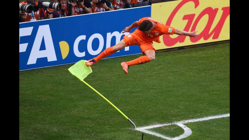Netherlands striker Klaas-Jan Huntelaar kicks the corner flag in celebration after he scored a stoppage-time penalty kick against Mexico during a World Cup match Sunday, June 29, in Fortaleza, Brazil. It proved to be the difference as the Netherlands won 2-1 and advanced to the quarterfinals of the soccer tournament.