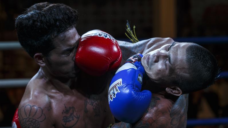 Thai prisoner Chanmansuk P.U. Suphap, right, fights Mnajande Msidmata of Myanmar during a Muay Thai bout Thursday, June 26, at the Klong Prem prison in Bangkok, Thailand. A Muay Thai program <a href="http://cnnphotos.blogs.cnn.com/2014/06/01/thailands-science-of-8-limbs/">began at the prison last year</a> to help rehabilitate inmates. For some, success against foreign challengers has knocked time off their sentences.