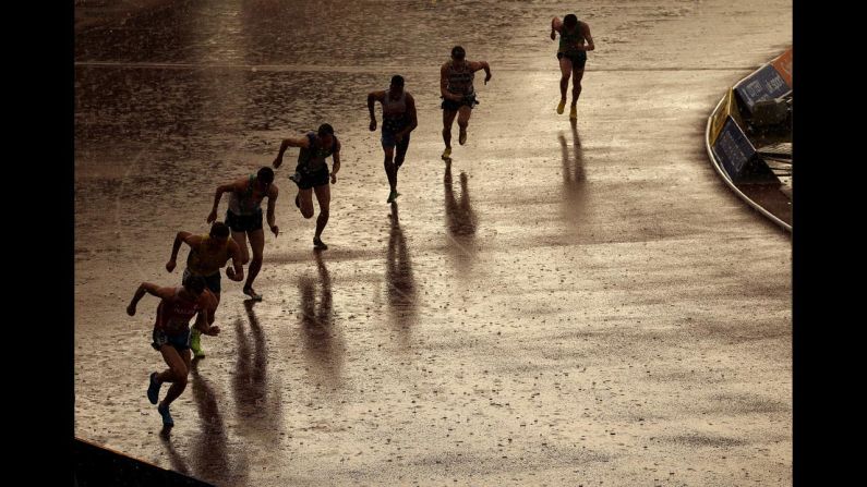 Athletes start an 800-meter race during heavy rain at the British Athletics Championships in Birmingham, England, on Friday, June 27.