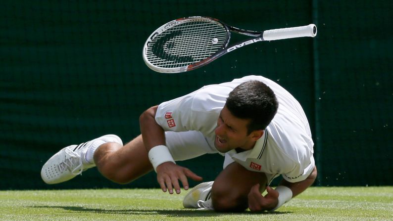 Novak Djokovic falls during his Wimbledon match against Gilles Simon on Friday, June 27, in London. Djokovic hurt his shoulder but went on to beat Simon in straight sets and advance to the fourth round of the tournament. 