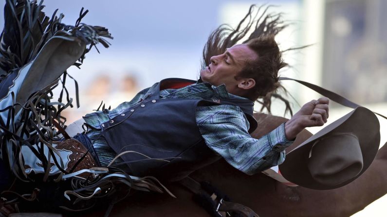 Kyle Brennecke loses his hat Wednesday, June 25, as he competes in bareback bronc riding at the Reno Rodeo in Reno, Nevada.