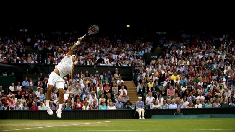Roger Federer hits a shot during his third-round match against Santiago Giraldo at Wimbledon on Saturday, June 28. Federer, a seven-time Wimbledon champion, won the match in straight sets.