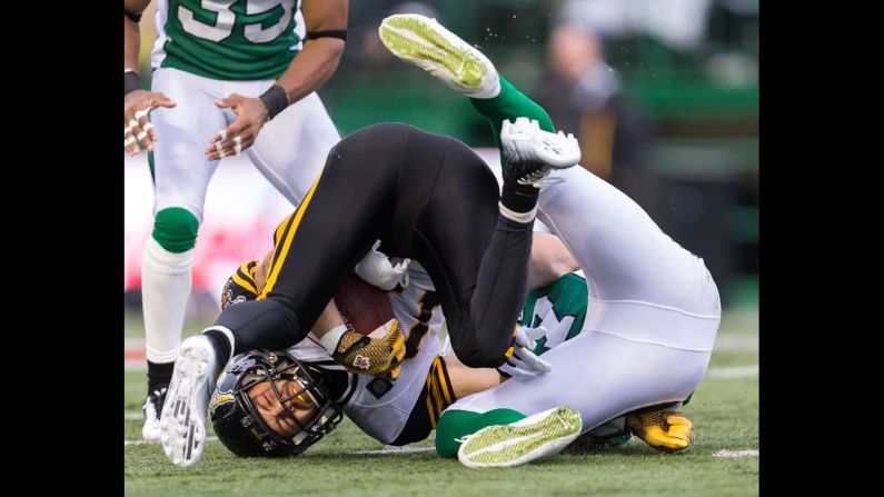 Luke Tasker of the Hamilton Tiger-Cats is tackled during a Canadian Football League game against the Saskatchewan Roughriders on Sunday, June 29, in Regina, Saskatchewan. The Roughriders, the defending CFL champions, opened their new season with a 31-10 victory.