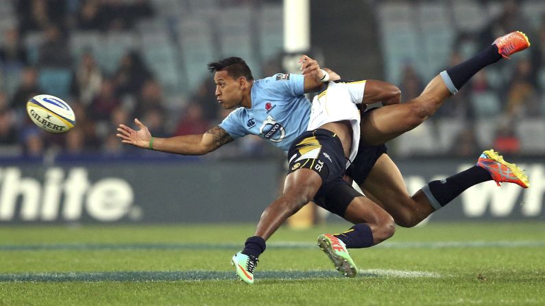 Israel Folau of the New South Wales Waratahs, left, is tackled by the Brumbies' Tevita Kuridrani during a Super Rugby match in Sydney on Saturday, June 28.