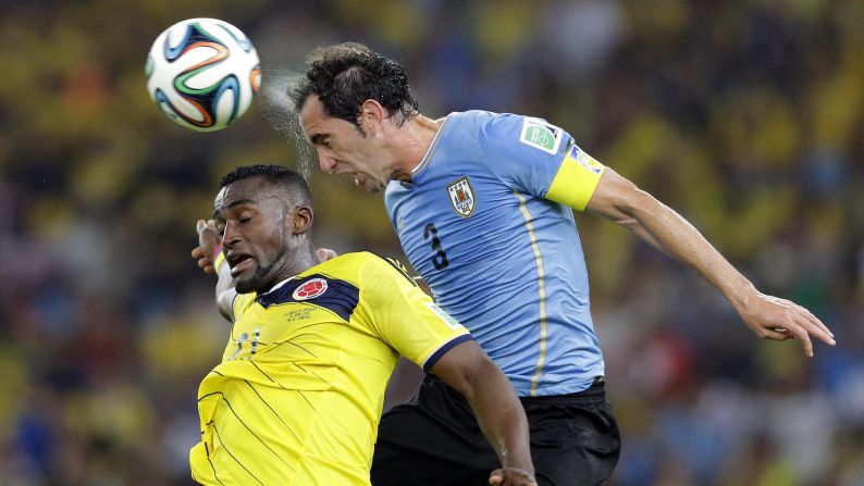 Uruguay's Diego Godin, right, and Colombia's Jackson Martinez go for a header during their World Cup round-of-16 match Saturday, June 28, in Rio de Janeiro. Colombia won 2-0 to advance to the quarterfinals.