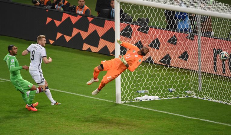 Andre Schuerrle, center, scores a backheel goal in extra time to give Germany a 1-0 lead over Algeria.