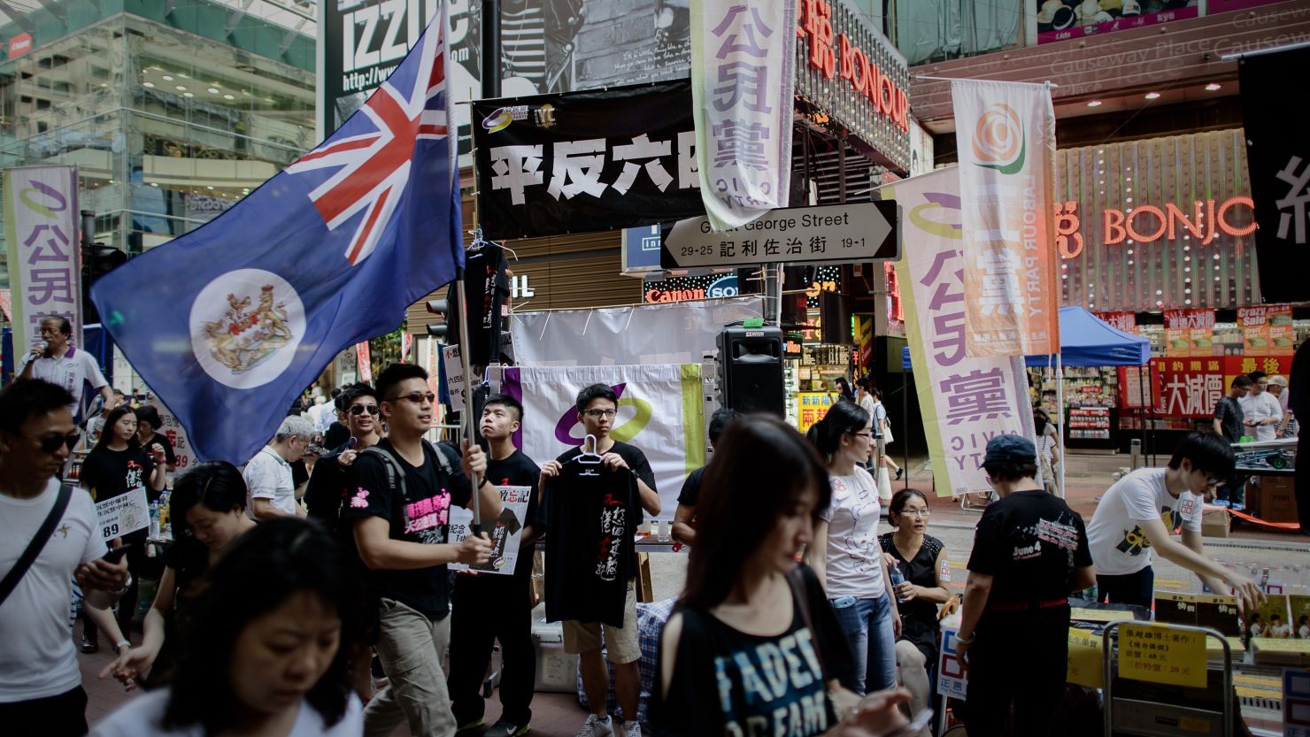 A man carries a Hong Kong colonial flag as part of the commemoration of China's 1989 Tiananmen Square military crackdown on pro-democracy protesters, in Hong Kong on June 4, 2014. 