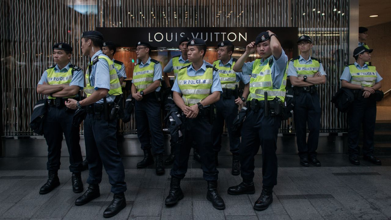 Policemen stood guard in front of a store in the Central district of Hong Kong during the rally.