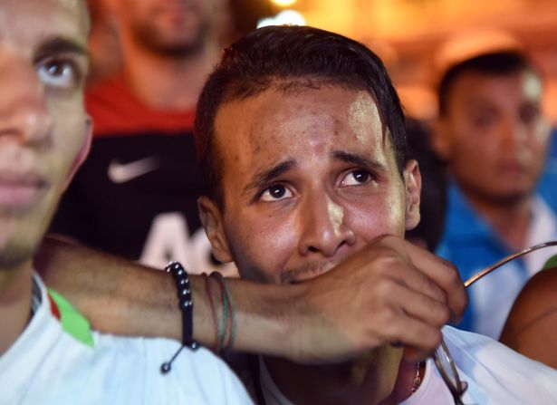 Disappointed fans of Algeria react during a public screening of the Germany match in Algiers, Algeria.
