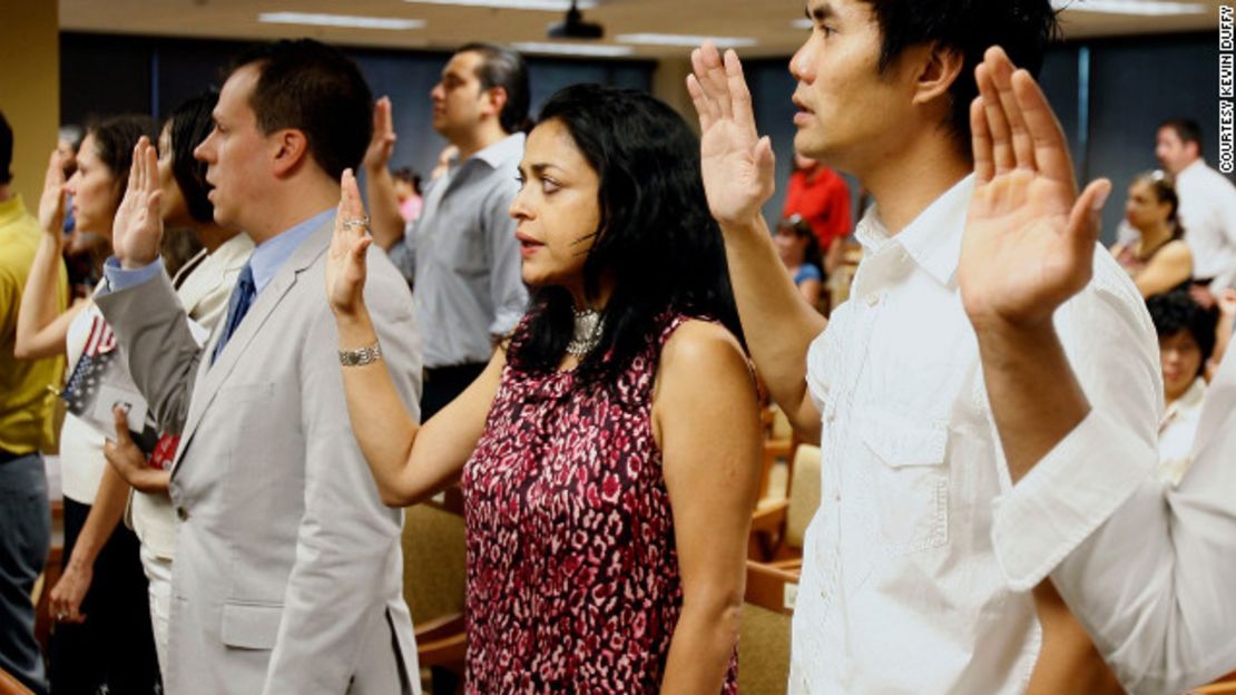 The author, Moni Basu, center, says the Pledge of Allegiance at her naturalization ceremony in 2008.