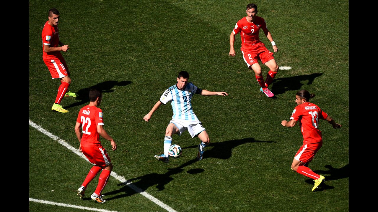 Swiss players surround Messi in the first half.
