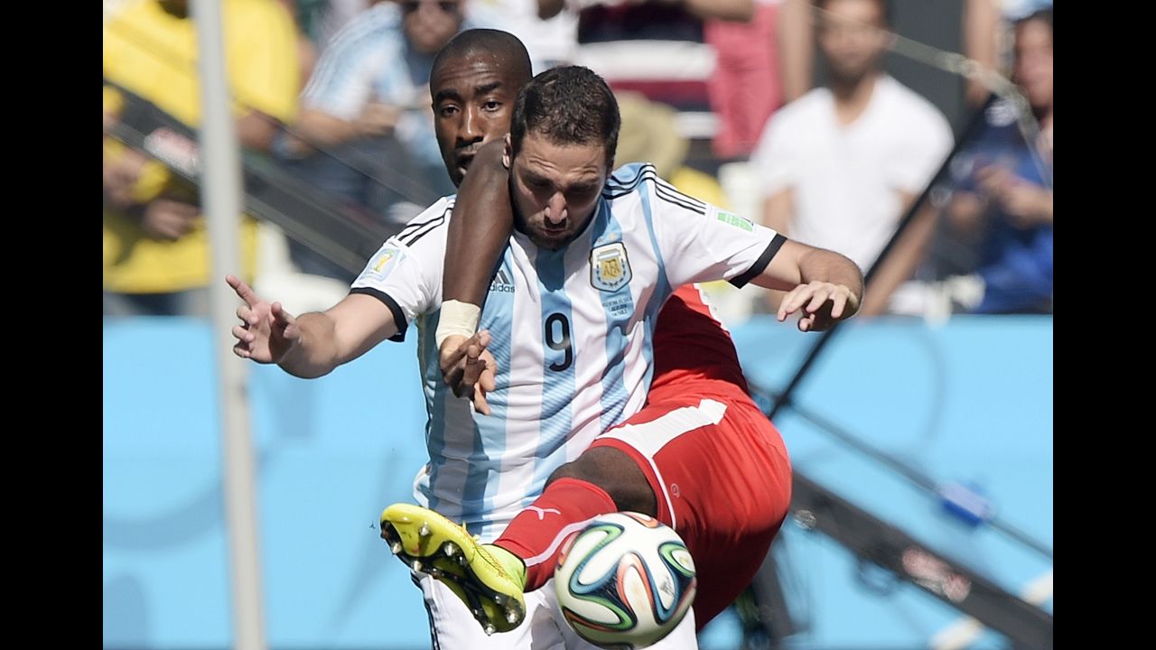 Djourou, back, and Argentine forward Gonzalo Higuain compete for the ball.
