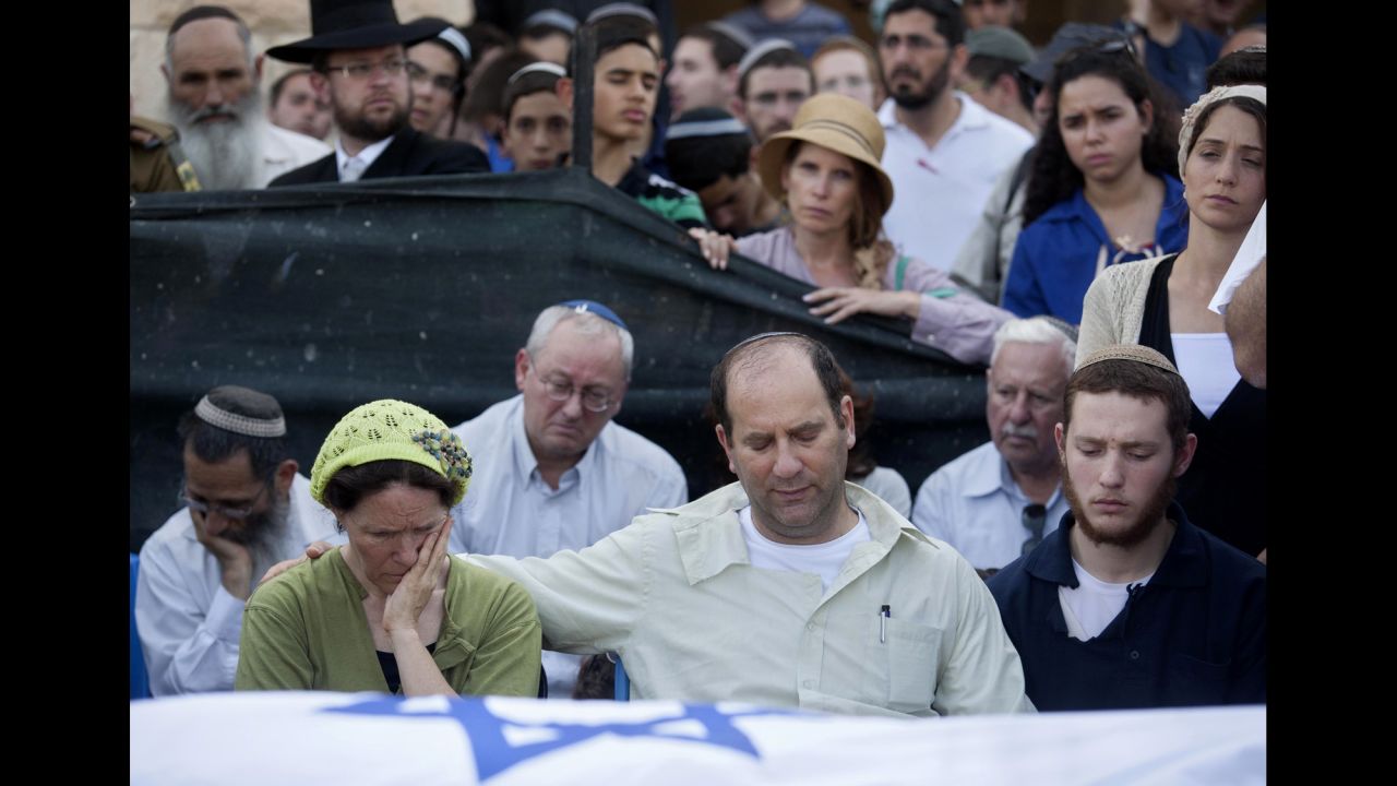 Avi and Rachel Frankel attend the funeral of their son, Naftali, in the West Bank settlement of Nof Ayalon on July 1. He was 16.
