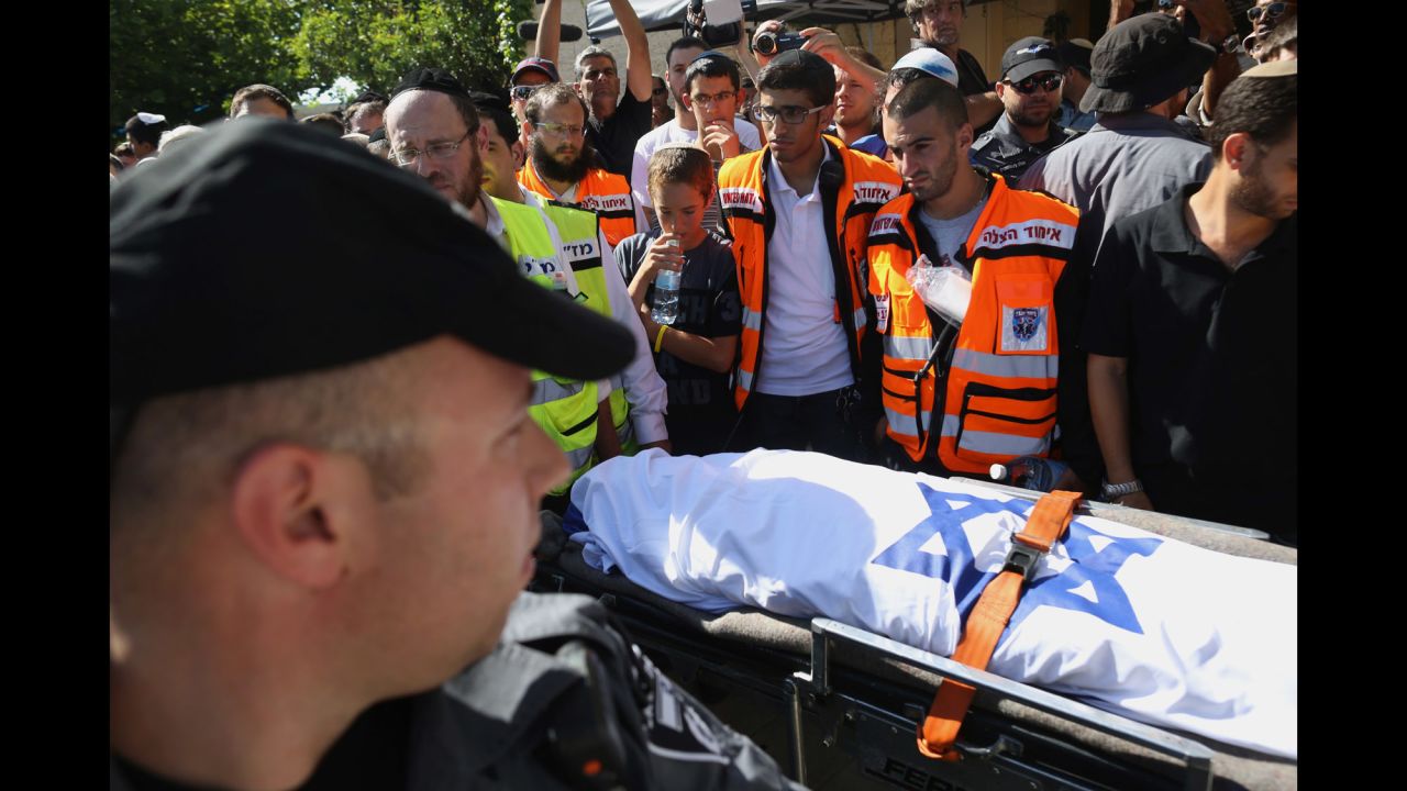 Mourners gather around the body of Gilad Shaar, 16, during his funeral ceremony July 1 in Talmon, West Bank.