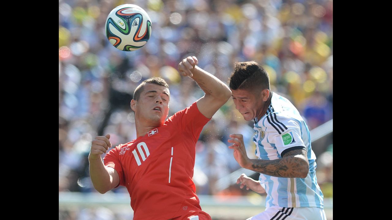 Marcos Rojo of Argentina, right, fights for the ball against Granit Xhaka of Switzerland.