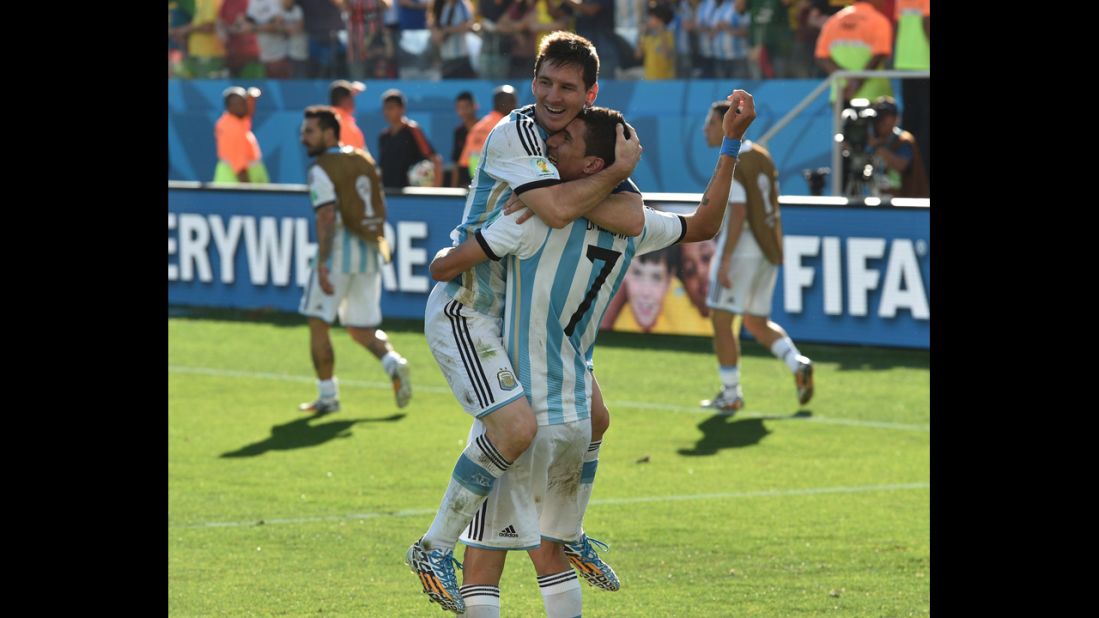 Argentina players Lionel Messi, left, and Angel Di Maria celebrate after Di Maria scored the winning goal in extra time to beat Switzerland 1-0 and advance to the World Cup quarterfinals.