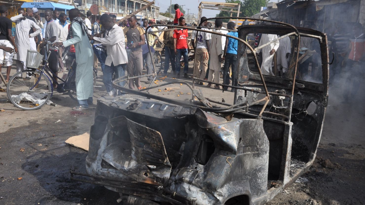 People gather at the scene of a car bomb explosion, at the central market, in Maiduguri, Nigeria on July 1, 2014. 