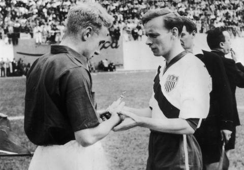 The American and English captains, Ed McIlvenny and Billy Wright exchange souvenirs prior to their game at the Brazil World Cup in 1950. Their first success at the World Cup came in this game with a surprise 1-0 victory over England. USA fans will be hoping for the same success at this year's World Cup finals. 