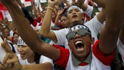 Supporters of Indonesian frontrunner presidential candidate Joko Widodo cheer during a campaign rally in Jakarta on June 26, 2014.