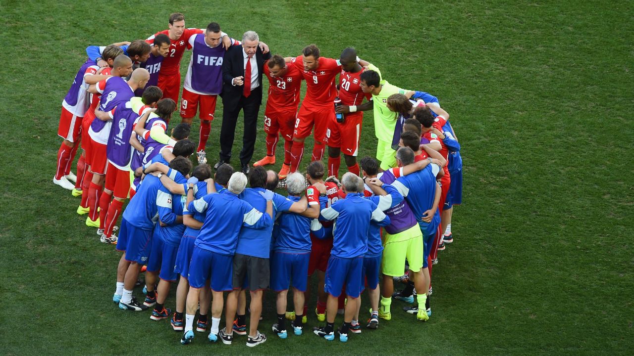 Swiss coach Ottmar Hitzfeld huddles with his players prior to the start of extra time.