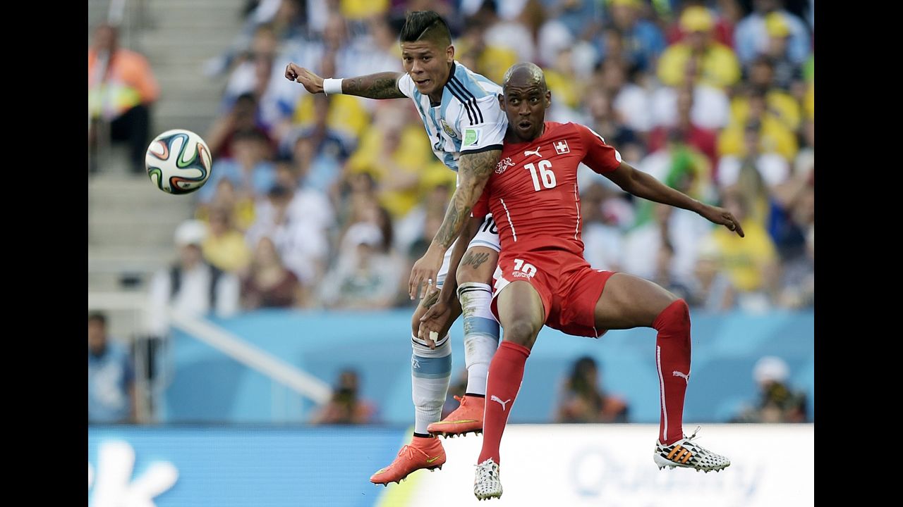 Swiss midfielder Gelson Fernandes, right, and Rojo compete for the ball.