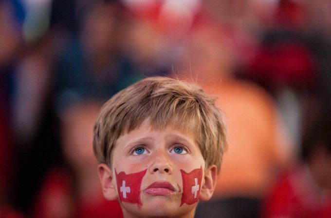 A young soccer fan in Lugano, Switzerland, watches a television screen during the live broadcast of the Switzerland-Argentina World Cup match on July 1.