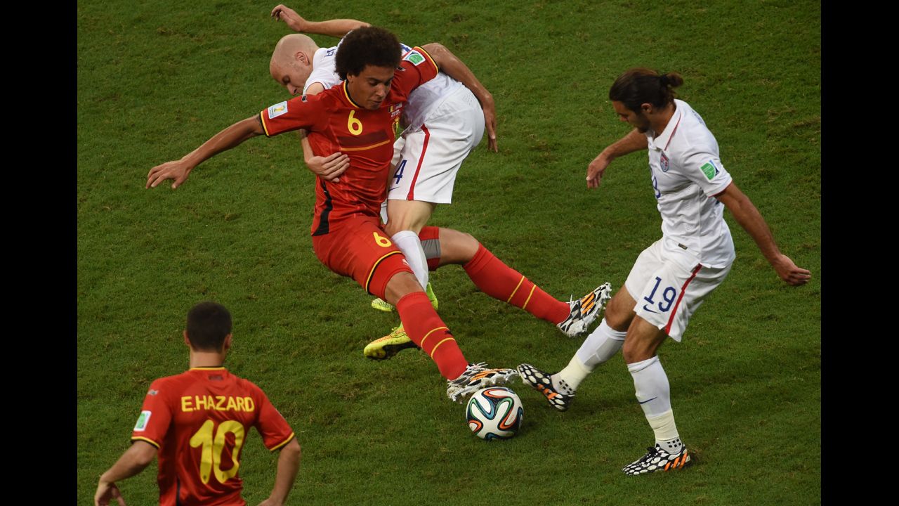 U.S. midfielders Michael Bradley, second from right, and Graham Zusi, right, compete against Witsel.