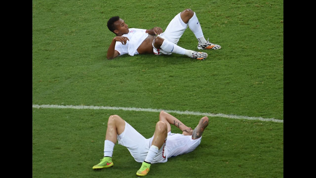 U.S. players Julian Green, top, and Geoff Cameron lie on the field after the match.