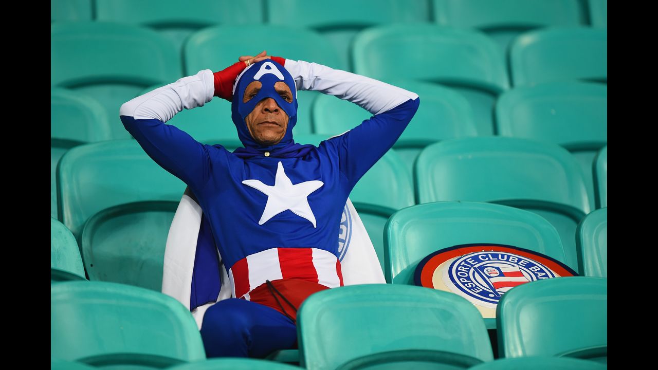 A fan dressed as Captain America looks on after Belgium's victory.