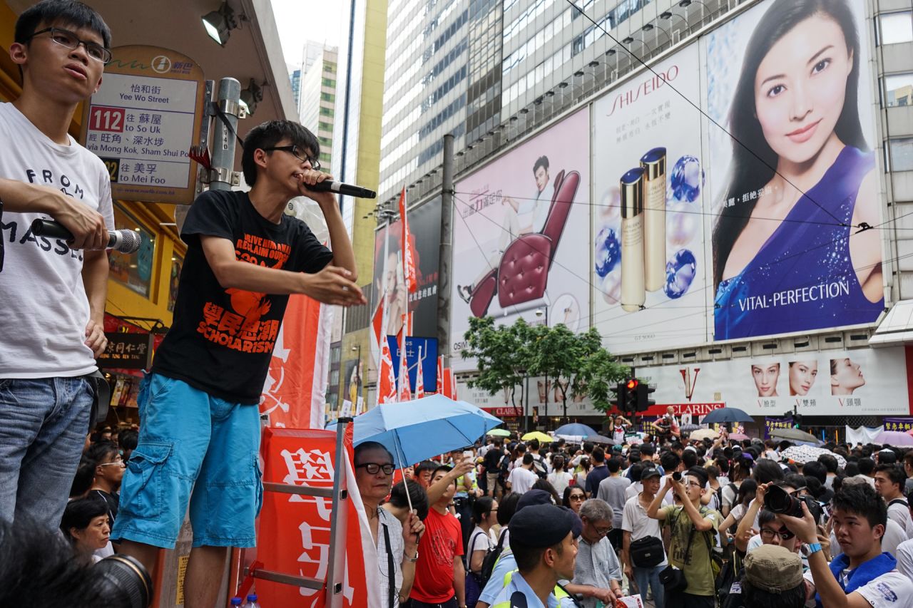 During the march, Joshua Wong, 17, the founder of pro-democracy student group Scholarism, announced he would stage an illegal sit-in on the night of July 1. "I may get arrested tonight. Will you all support me?" he yelled to the crowd.