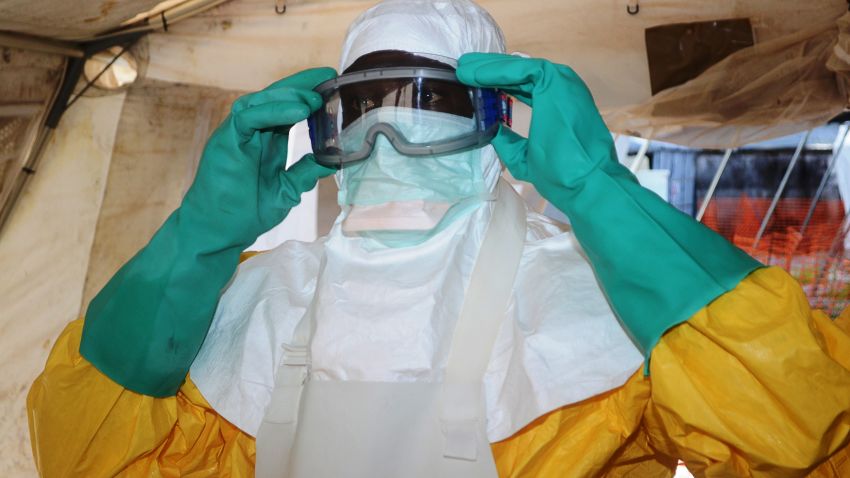 A picture taken on June 28, 2014 shows a member of Doctors Without Borders (MSF) putting on protective gear at the isolation ward of the Donka Hospital in Conakry, where people infected with the Ebola virus are being treated. The World Health Organization has warned that Ebola could spread beyond hard-hit Guinea, Liberia and Sierra Leone to neighbouring nations, but insisted that travel bans were not the answer. To date, there have been 635 cases of haemorrhagic fever in Guinea, Liberia and Sierra Leone, most confirmed as Ebola. A total of 399 people have died, 280 of them in Guinea. AFP PHOTO / CELLOU BINANI (Photo credit should read CELLOU BINANI/AFP/Getty Images)