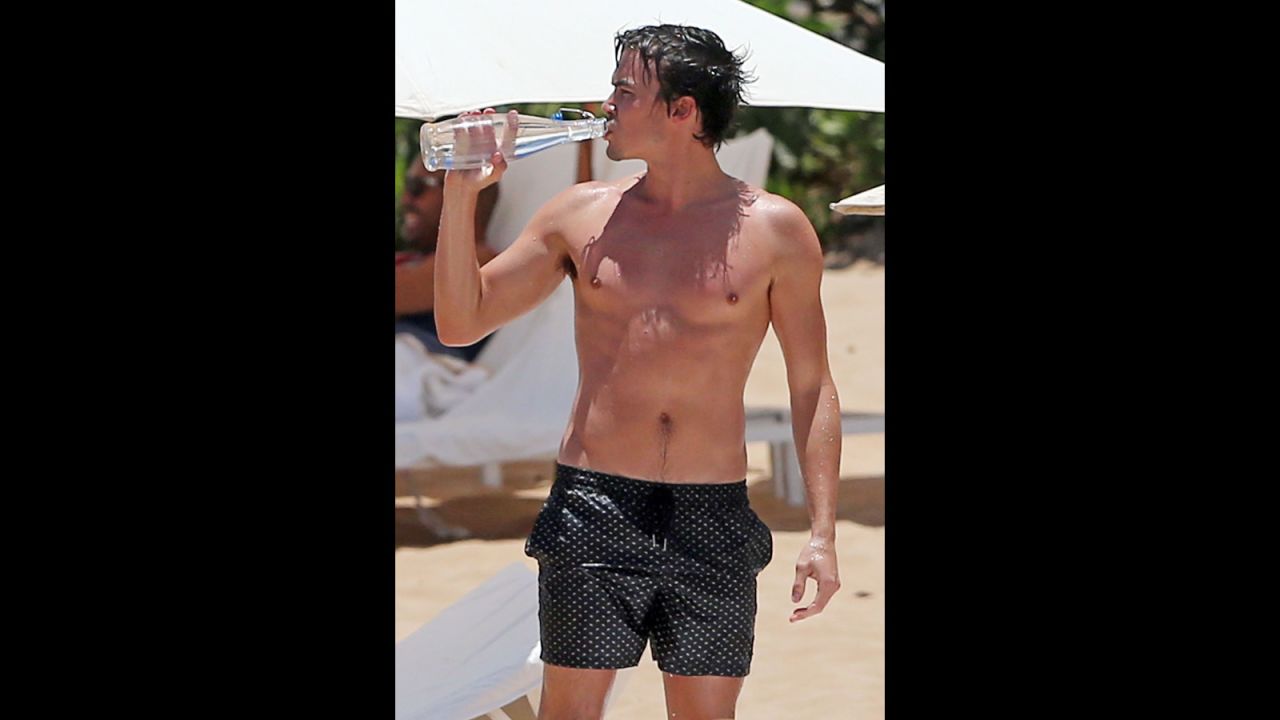 "Pretty Little Liars" star Tyler Blackburn made sure to stay hydrated while on the beach in Maui in July 2014.